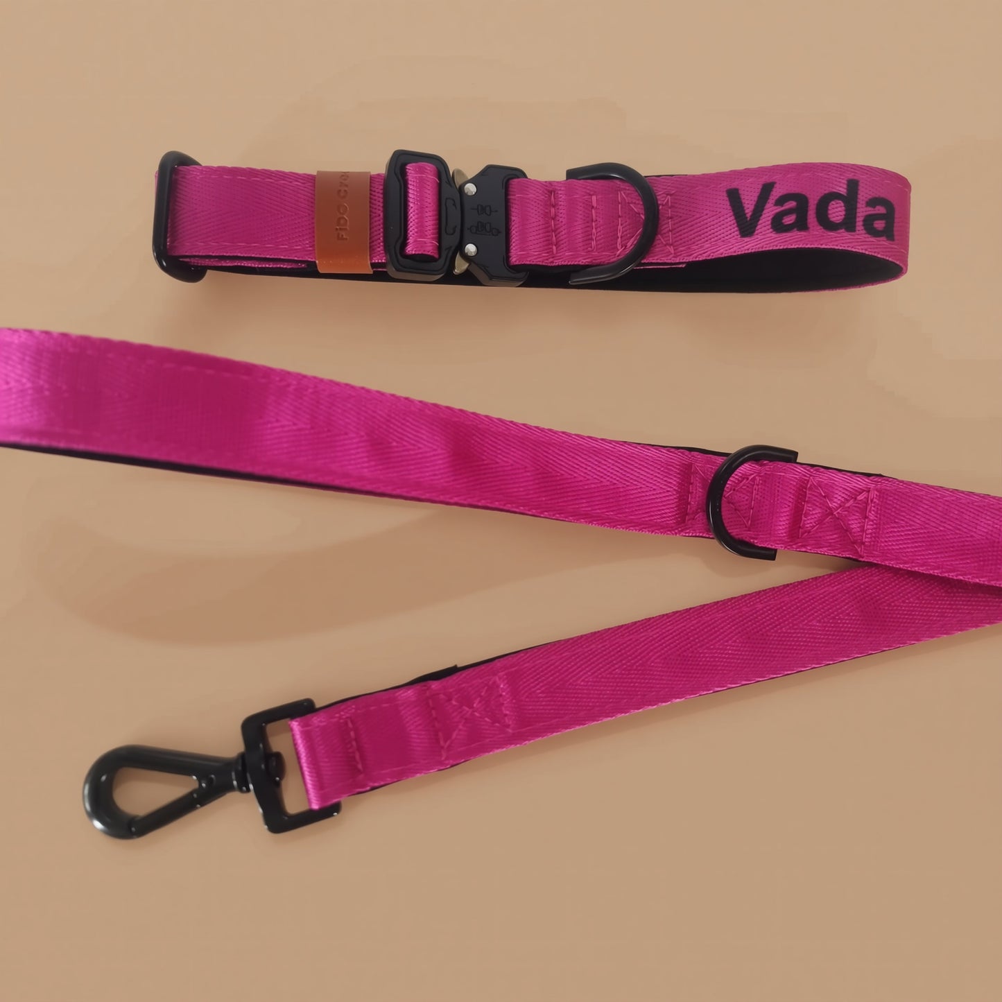 A pink dog leash with a black metal attachment and a black metal loop.