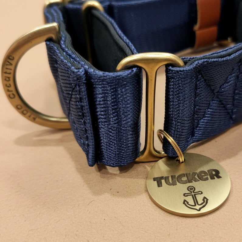 strong dog tag with deep engraving clipped onto a dog collar