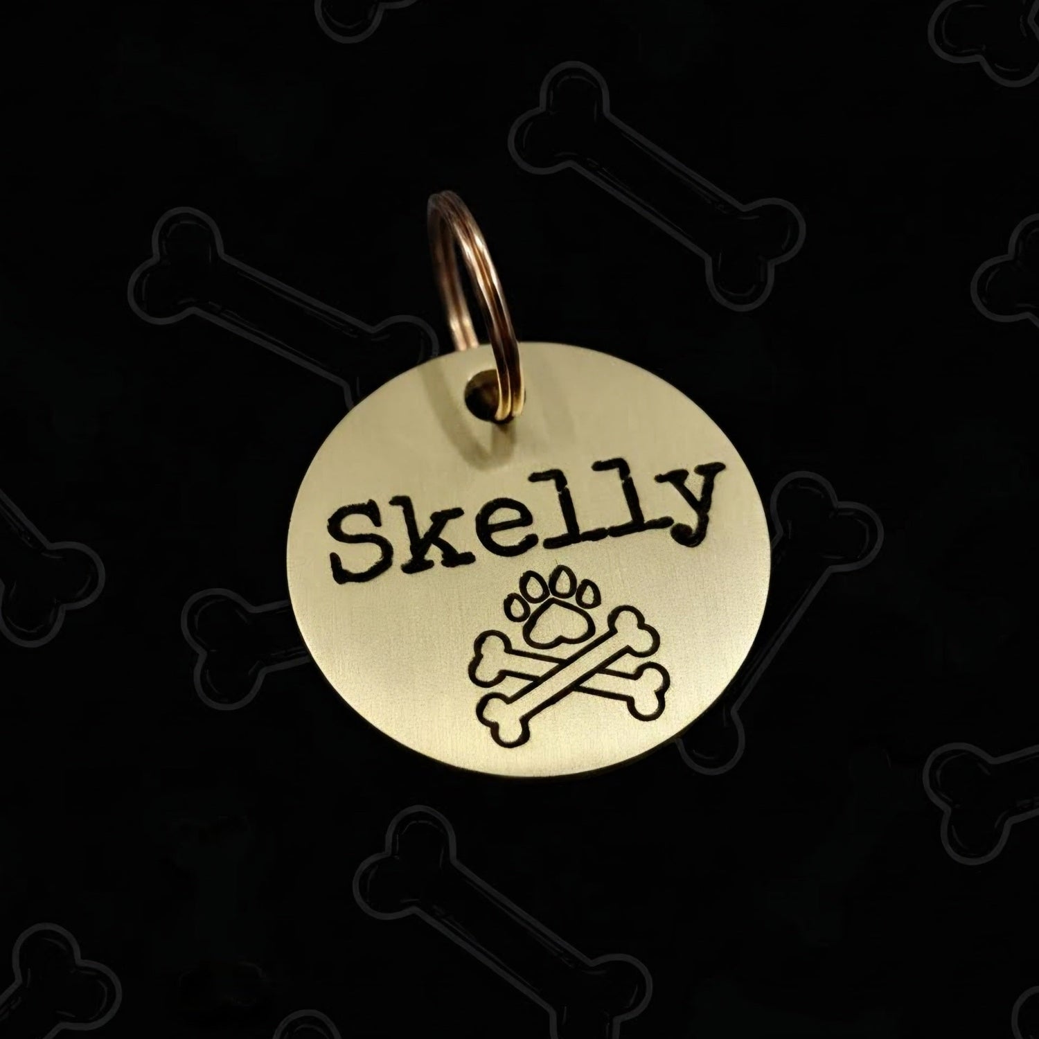 Gold pet tag with dog's name engraved and scull and crossbones